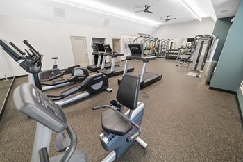 A room filled with lots of different types of exercise equipment